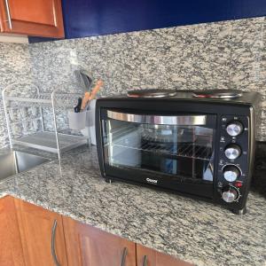 a toaster oven sitting on top of a kitchen counter at Sweetland Vesidences in Yaoundé