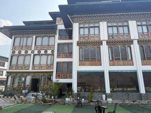 a large building with a courtyard in front of it at Tara Haven Hotel in Yuwak +11 photos