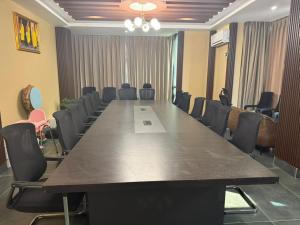 a large conference room with a long table and chairs at Tara Haven Hotel in Yuwak