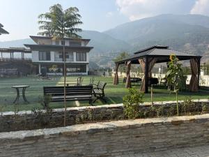 a park with benches and a gazebo and a house at Tara Haven Hotel in Yuwak