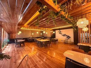 a restaurant with wooden floors and tables and chairs at Tara Haven Hotel in Yuwak