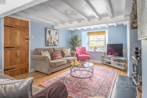 a living room with a couch and a table at Stunning Cottage with free Spa access in Newby Bridge