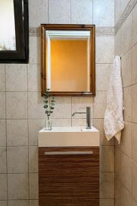 a bathroom with a sink and a mirror at Vivian's Villa - Endless View in Svoronata +71 photos