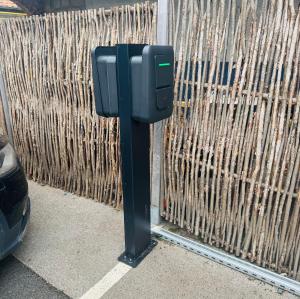 a parking meter in front of a fence at Hôtel Villa Des 2 Caps in Wimereux