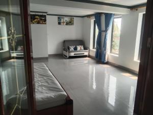 a room with a bed and a couch in it at Kì thanh hotel in Thanh Hóa