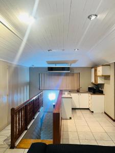 a kitchen with white cabinets and a counter top at Khans Residence in Gqeberha