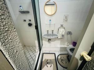 a small bathroom with a sink and a toilet at Khans Residence in Gqeberha +23 photos
