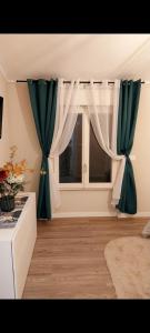 a room with a window with green and white curtains at Il limone in Gargnano