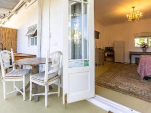 a kitchen and dining room with a table and chairs at Julie's Cottage in Riebeek-Kasteel