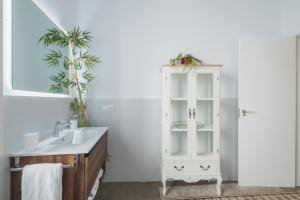 a bathroom with a white cabinet and a sink at Palacete de La Alameda - Adults Only- in Cádiz +95 photos