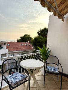 a balcony with a table and two chairs and a table at Apartments Robert in Tučepi