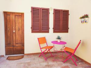 a table and two chairs and a table with a plant on it at Le Torri 3 San Gimignano in San Gimignano