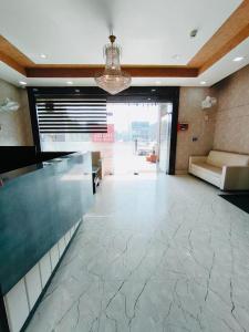 a lobby with a glass counter in a building at Hotel Golden Olive in Kurukshetra