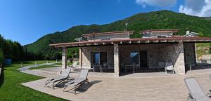 a group of chairs sitting on a patio at Oasi Da Vinci Apartments Lake Garda View in Tignale