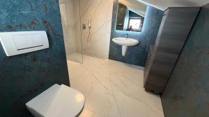 a bathroom with a toilet and a sink at Alpin-Check-in in Reutte +51 photos
