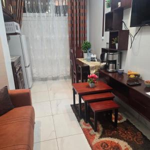 a living room with a table and a dining room at Sweetland Vesidences in Yaoundé