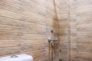 a bathroom with a toilet and a shower at Kanha Gold in Bhopal