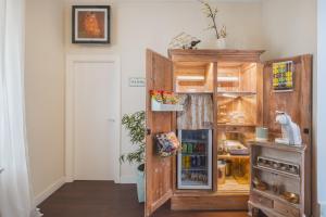 a kitchen with a wooden cabinet with a refrigerator at Palacete de La Alameda - Adults Only- in Cádiz