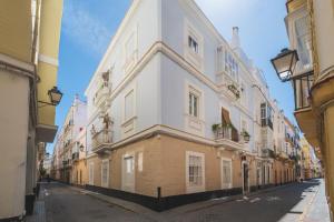 a large white building on a street at Palacete de La Alameda - Adults Only- in Cádiz