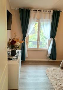 a kitchen with green curtains and a window at Il limone in Gargnano