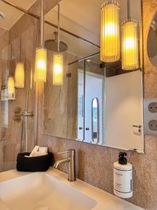 a bathroom with a sink and a mirror at Eiffel Yard Hotel in Paris +56 photos
