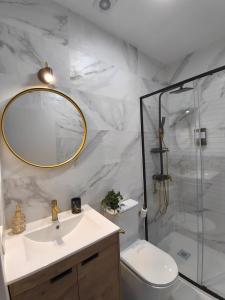 a bathroom with a toilet and a sink and a shower at Casa Molino San Antonio in Córdoba +55 photos