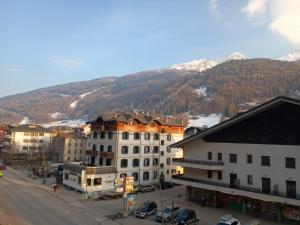 a city with buildings and a mountain in the background at Castle house in Aprica