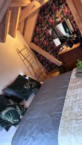 a bedroom with a large bed and a staircase at SLEEP INN Bed&Breakfast in Amblève