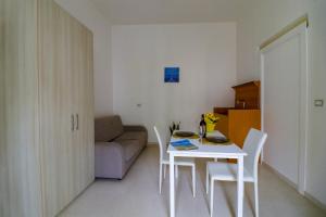 a small living room with a white table and chairs at Elaia's House in Cannole in Cannole