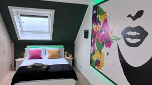 a bedroom with a bed with a superhero painting on the wall at SLEEP INN Bed&Breakfast in Amblève