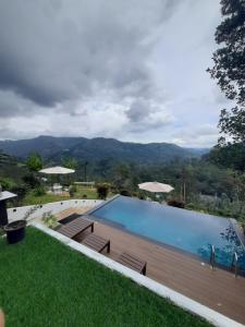 a swimming pool with a view of the mountains at Idyll Cottage Ella in Ella