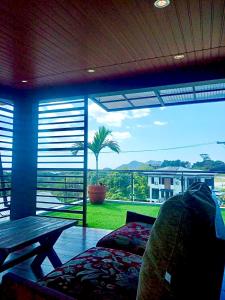 a living room with a table and a large window at Staycation at Sandari Batulao Overlooking Spot in Calo