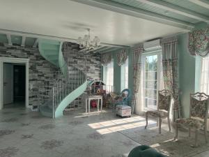 a living room with a staircase and a room with chairs at Dacha Del Mar in Yasnogorodka +36 photos
