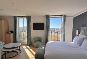 a hotel room with a bed and a large window at Eiffel Yard Hotel in Paris
