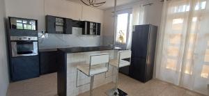 a kitchen with a black and white counter top at Life and memory in Blue Bay