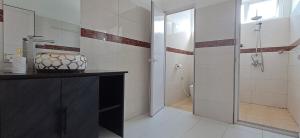 a bathroom with a shower and a sink and a toilet at Life and memory in Blue Bay