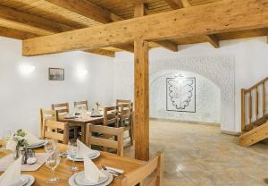 a dining room with wooden tables and chairs at Penzion Čítkův Mlýn in Šluknov