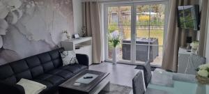 a living room with a couch and a table at Casa Mia 36 am See in Joachimsthal