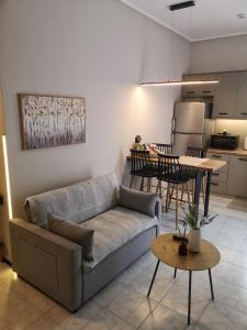 a living room with a couch and a table and a kitchen at Nord Guesthouse in Neos Pirgos +30 photos