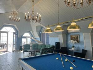 a billiard room with a pool table and chairs at Dacha Del Mar in Yasnogorodka