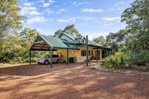 a house with a car parked in front of it at Yallingup Surfing wineries and restaurants in Yallingup