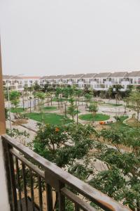 a balcony of a apartment building with a park at DeHa Homestay in Kon Rung (1)