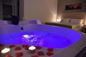 a purple bath tub with lights in a room at Favorite Room&Spa in San Giuseppe Vesuviano
