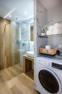 a washing machine in a bathroom with a shower at Odaria Premium Apartments in Lampi +106 photos