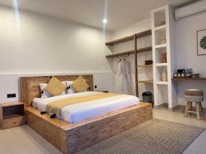 a bedroom with a large wooden bed and shelves at Aluna Villa Kintamani - Private villa & Hot spring pool in Kubupenlokan