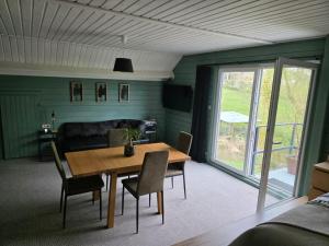 a dining room with a wooden table and chairs at StayTommy in Bertem