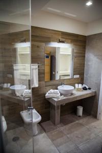 a bathroom with two sinks and two mirrors at Favorite Room&Spa in San Giuseppe Vesuviano +8 photos