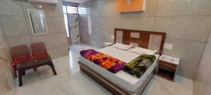 a bedroom with a bed and a table and a chair at Pamma hotel in Anandpur Sāhib