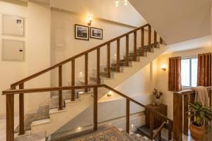 a staircase with wooden railings in a home at Hotel Shumo Grand Khammam in Khammam