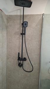 a shower in the corner of a room at appartement luna 1 in Dinant